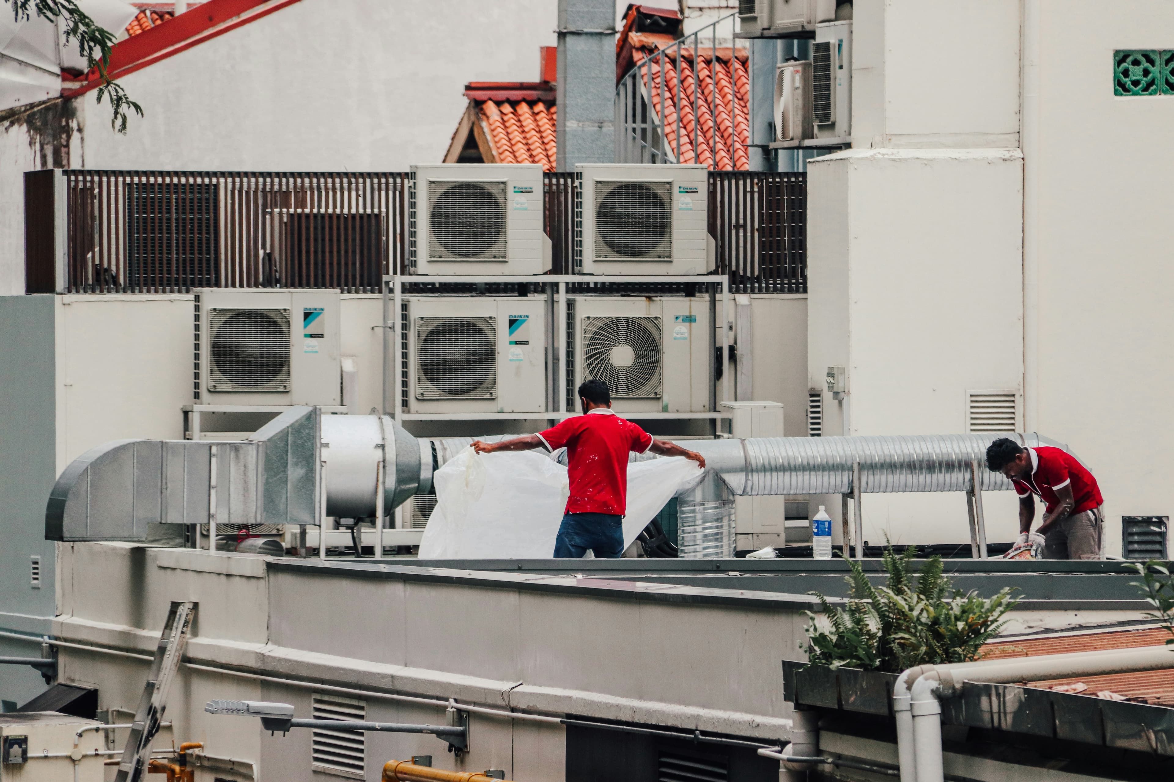 HVAC technician working on commercial pipes and equipment
